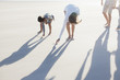 Family writing in sand on beach