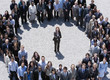 Photo : Portrait of businesswoman standing at center of circle formed by business people Portrait of businesswoman standing at center of circle formed by business people
