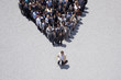 Businessman at apex of pyramid formed by crowd