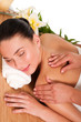 Relaxed beautiful young woman having a spa massage on her back