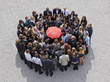 Umbrella at center of circle formed by business people