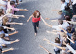 Woman walking through crowd with arms outstretched