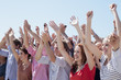 Cheering crowd with arms raised