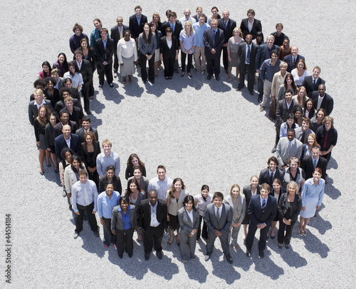 Photo: Portrait of smiling business people forming circle Portrait of smiling business people forming circle