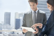 Businessman and businesswoman with digital tablet on urban balcony