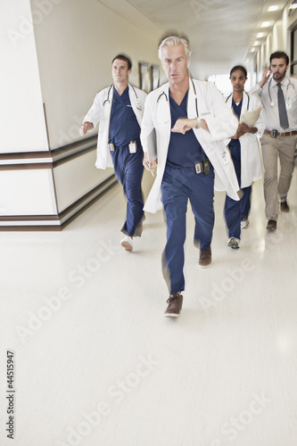 Photo: Doctors rushing down hospital corridor Doctors rushing down hospital corridor