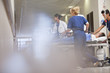 Doctors and nurses wheeling patient in 