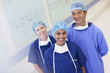 Portrait of smiling surgeon and nurses in hospital corridor