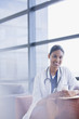 Portrait of smiling doctor drinking coffee