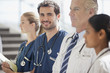 Portrait of smiling nurse with doctors