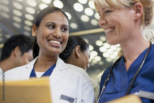 Photo: Smiling doctor and nurse in elevator Smiling doctor and nurse in elevator