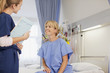 Nurse with medical record talking to patient in hospital room