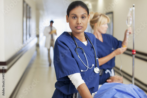 Photo: Nurses with patient on gurney in hospital corridor Nurses with patient on gurney in hospital corridor