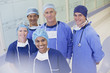 Portrait of smiling surgeons and nurses in hospital corridor