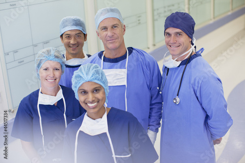 Photo: Portrait of smiling surgeons and nurses in hospital corridor Portrait of smiling surgeons and nurses in hospital corridor