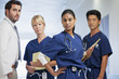 Portrait of serious doctor and nurses in hospital corridor