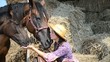 Video: Young Beautiful Girl and her horses resting near a haystack Young Beautiful Girl and her horses resting near a haystack