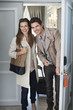 Smiling couple opening hotel room door