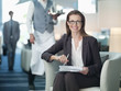 Portrait of smiling businesswoman working in hotel lounge