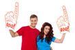 Young couple showing boo hurray foam hand