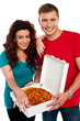 Cheerful love couple enjoying pizza together