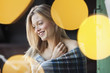 Smiling woman wrapped in a blanket