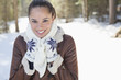 Portrait of smiling woman in snowy woods