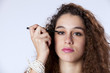 Woman applying the eyeliner