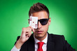 business man covers one eye with an ace of hearts