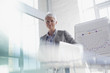 Photo: Confident businesswoman standing next to chart in conference room Confident businesswoman standing next to chart in conference room