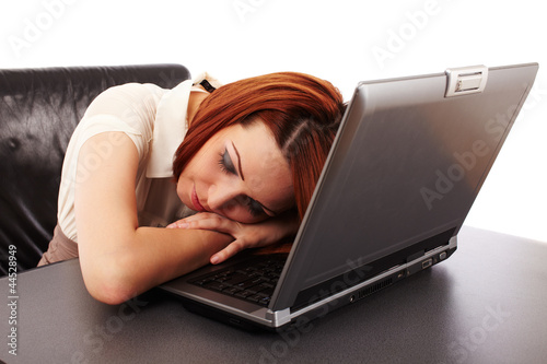 Photo: Woman sleeping on her computer Woman sleeping on her computer
