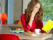 Young beautiful student girl  in the cafe