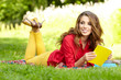 beautiful student reading and relaxing in park