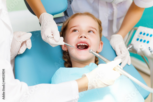 Photo: Little girl visiting dentist Little girl visiting dentist