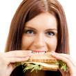Photo: Cheerful woman eating sandwich with cheese Cheerful woman eating sandwich with cheese
