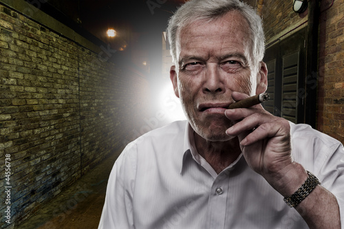 Photo: Senior man smoking a cigar Senior man smoking a cigar