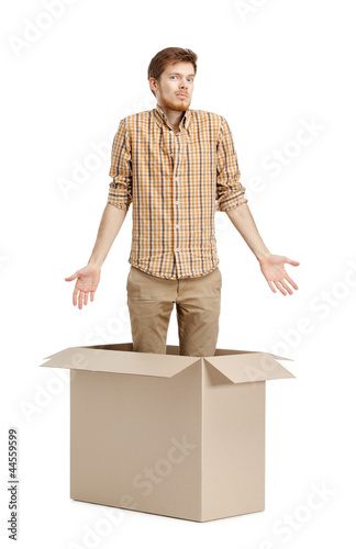 Photo: Young man doesn't know why he is inside the box Young man doesn't know why he is inside the box