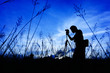 Silhouette of the photographer on a Grass on a foreground