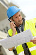 Portrait of construction manager using walkie-talkie