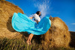 portrait of a girl next to haystack