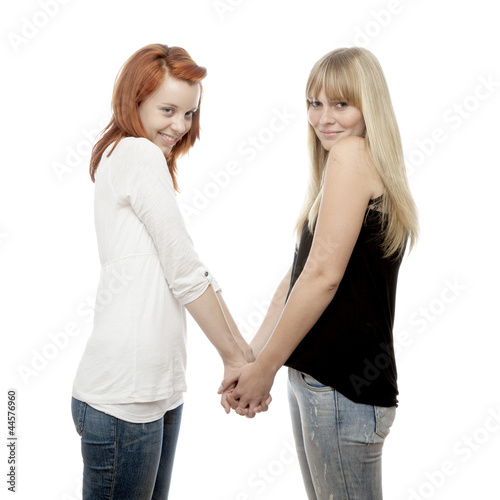 Photo: young beautiful red and blond haired girls holding hands young beautiful red and blond haired girls holding hands