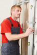 Young carpenter man worker with level