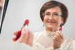 Photo: senior woman near the mirror senior woman near the mirror