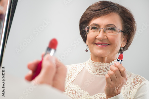 Photo: senior woman near the mirror senior woman near the mirror