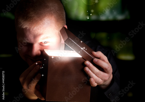 Photo: Man Opening a Gift Box Man Opening a Gift Box