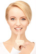 happy woman with finger on lips