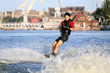 Wakeboarder surfing across a river