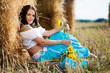 portrait of a girl next to haystack