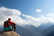 Climbing young adult at the top of summit