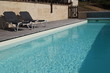 Swimming pool with sun loungers